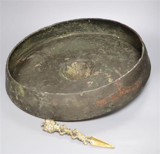 A Himalayan bronze phurba, 19.5cm and an Oriental gong, diameter 46cm